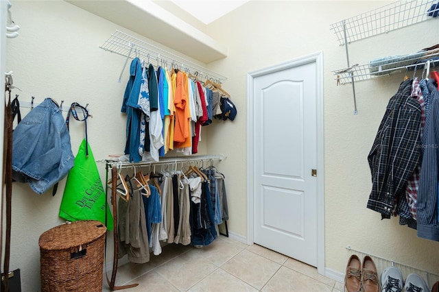 walk in closet with light tile patterned flooring