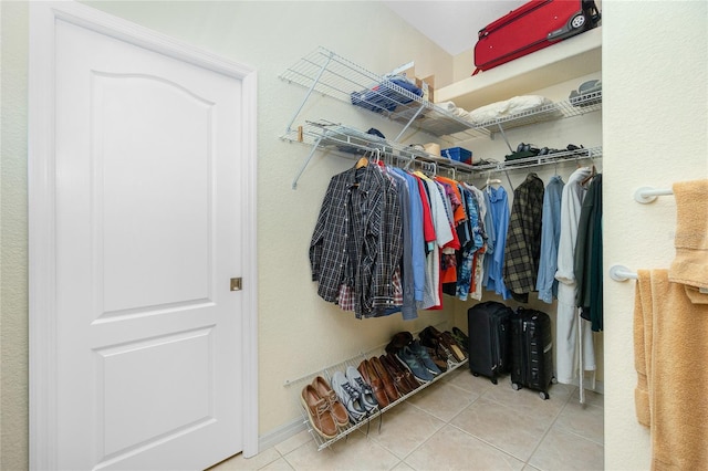 walk in closet with tile patterned floors