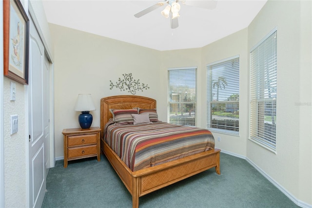 bedroom featuring dark colored carpet, a closet, and ceiling fan