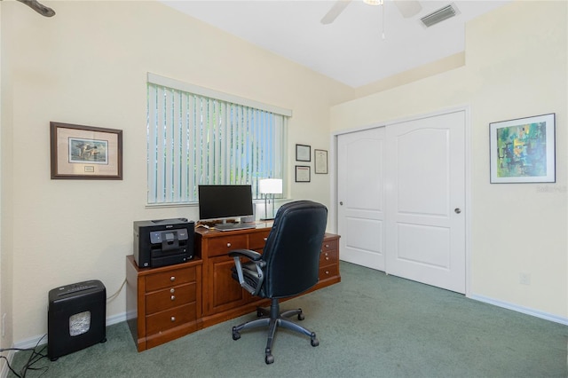 carpeted office space featuring ceiling fan