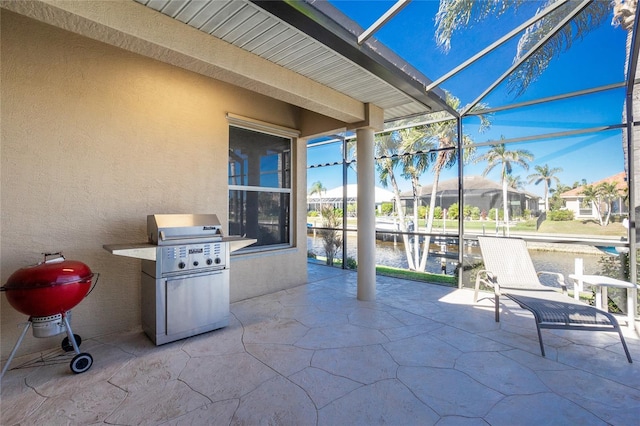 view of patio / terrace with glass enclosure, a grill, and a water view