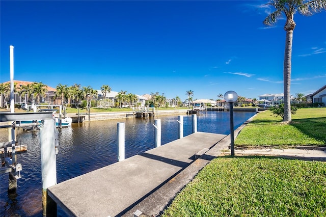 view of dock featuring a yard and a water view