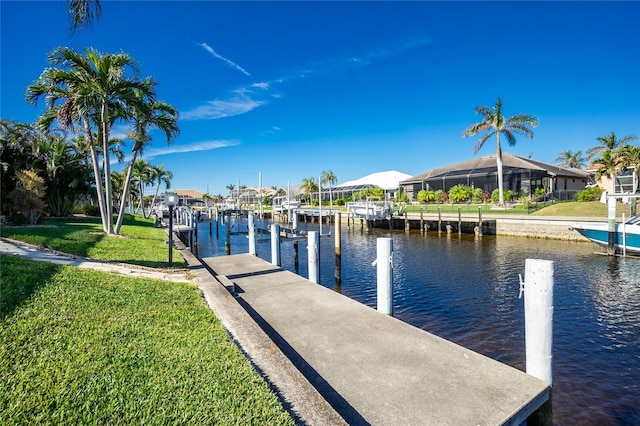 dock area with a water view and a yard