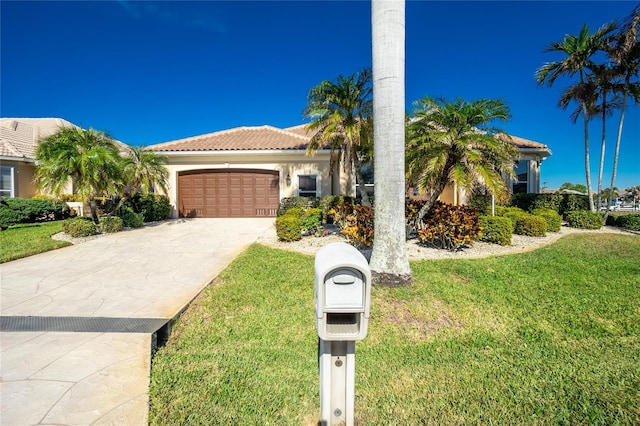 view of front of property with a front yard and a garage