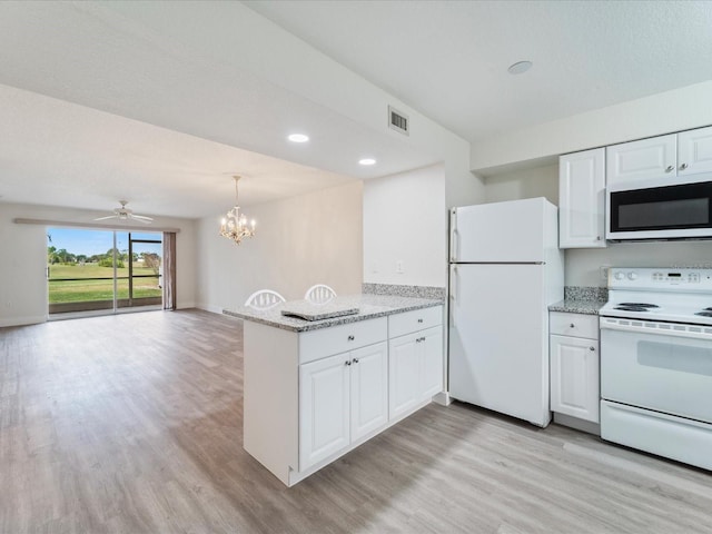 kitchen with white appliances, white cabinets, light wood-type flooring, light stone counters, and kitchen peninsula