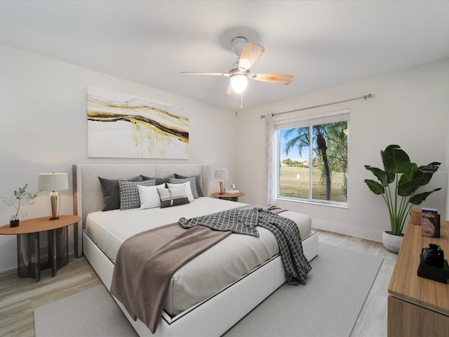 bedroom featuring light hardwood / wood-style flooring and ceiling fan