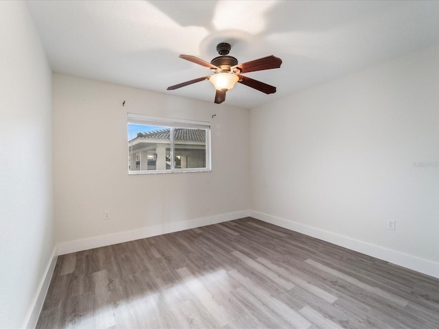 unfurnished room with ceiling fan and wood-type flooring