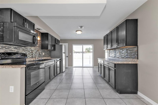 kitchen featuring tasteful backsplash, sink, light tile patterned floors, and black appliances