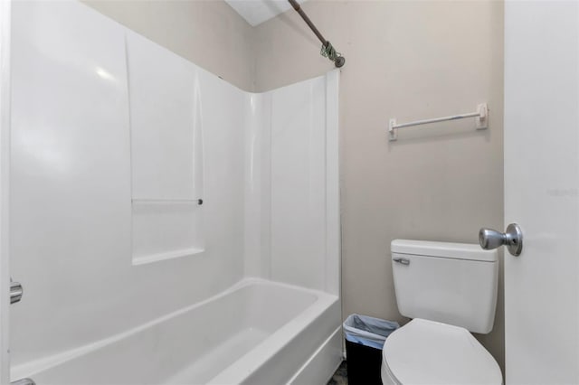 bathroom featuring bathtub / shower combination and toilet