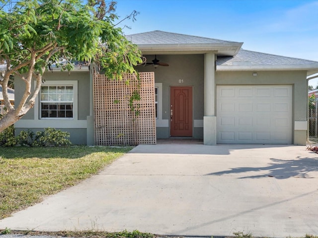 doorway to property featuring ceiling fan, a yard, and a garage