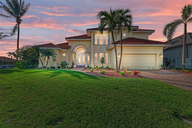 mediterranean / spanish house featuring a yard