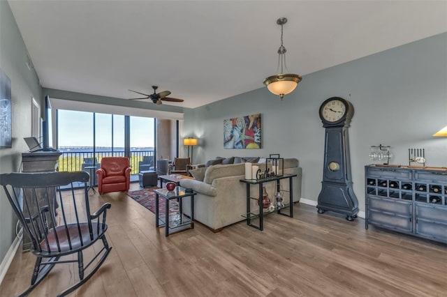 living room featuring ceiling fan and wood-type flooring