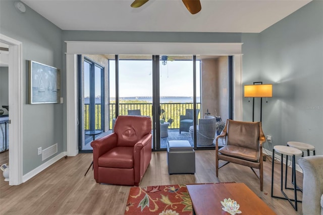 living room featuring ceiling fan and light wood-type flooring