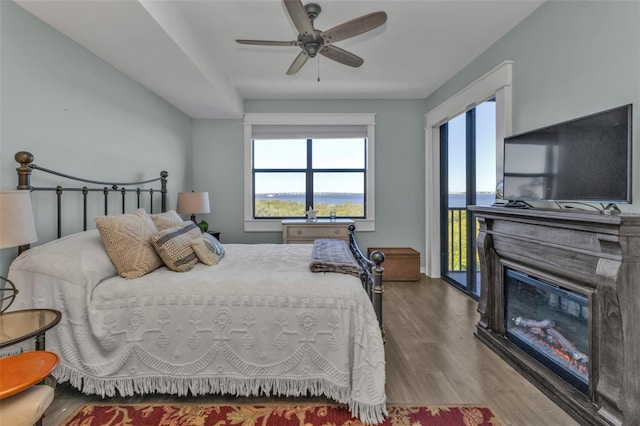 bedroom with ceiling fan, access to exterior, and light hardwood / wood-style floors