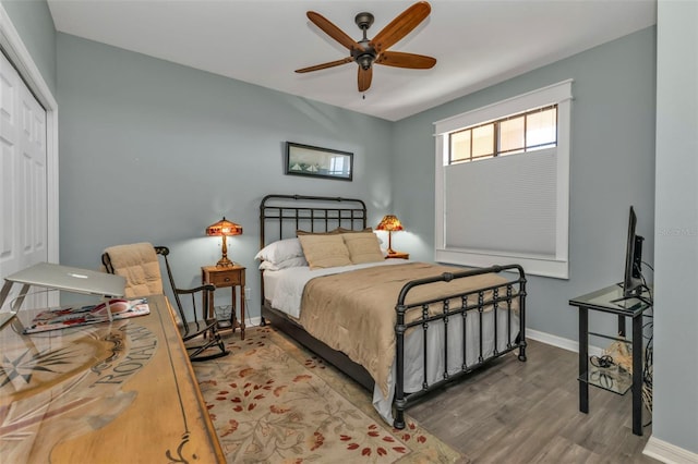 bedroom featuring hardwood / wood-style flooring, ceiling fan, and a closet