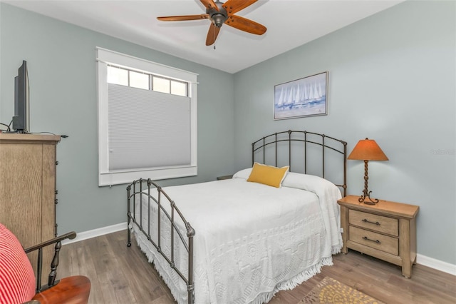 bedroom featuring hardwood / wood-style flooring and ceiling fan