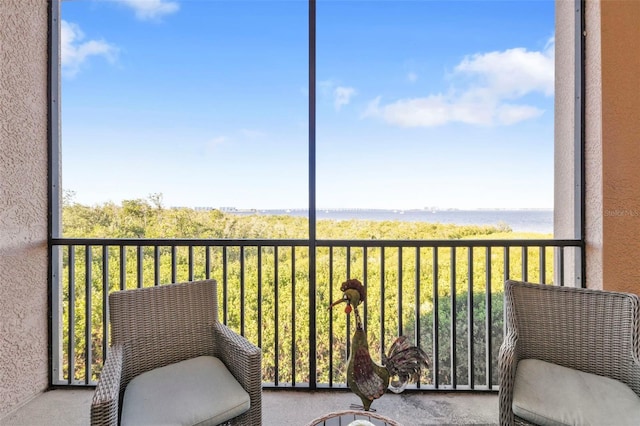 balcony featuring a water view