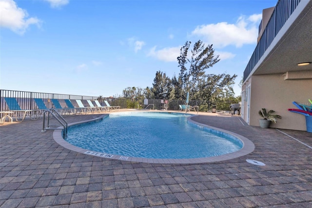 view of swimming pool featuring a patio area