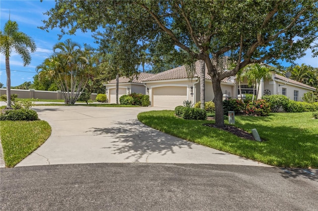 view of front of house featuring a garage and a front lawn