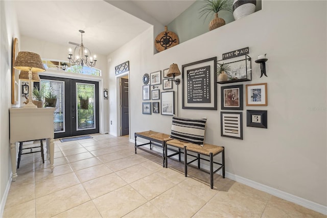 tiled foyer featuring a chandelier and french doors