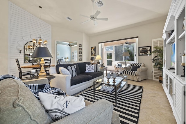 living room with light tile patterned floors, an inviting chandelier, and vaulted ceiling