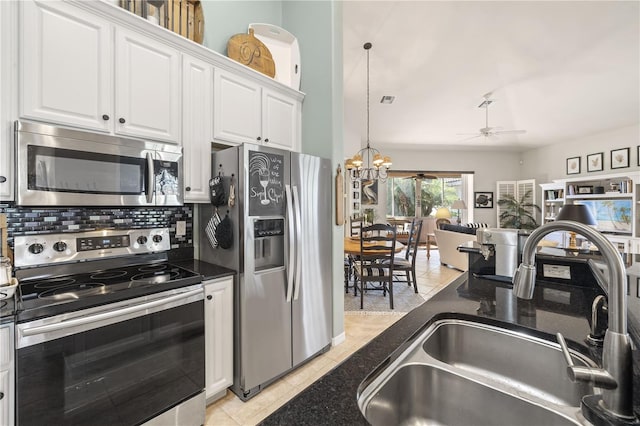 kitchen featuring white cabinetry, sink, stainless steel appliances, backsplash, and ceiling fan with notable chandelier