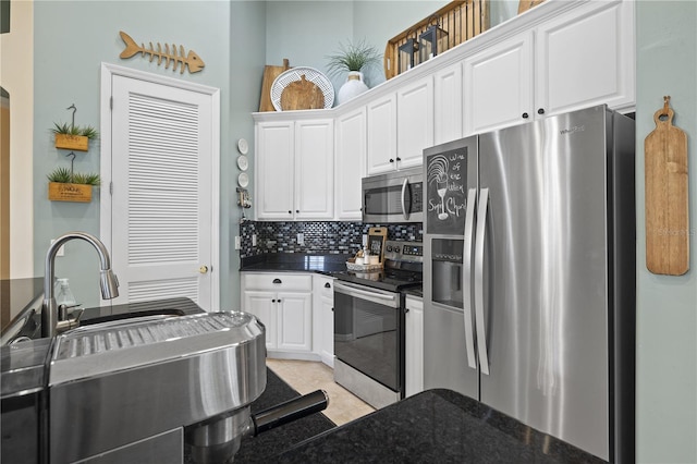 kitchen featuring white cabinets, decorative backsplash, light tile patterned flooring, and appliances with stainless steel finishes