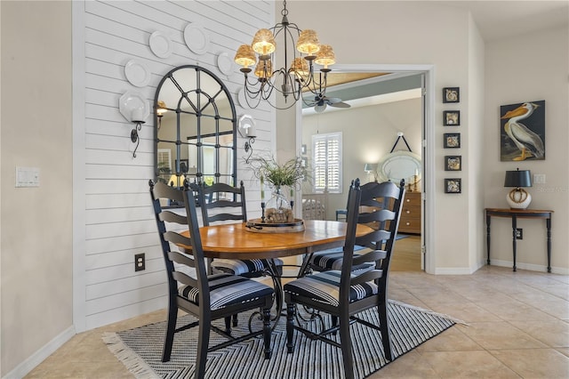 dining room with light tile patterned flooring and ceiling fan with notable chandelier