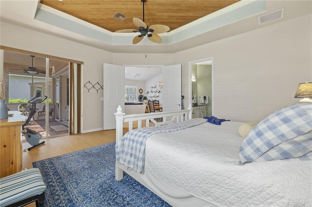 bedroom with access to outside, a tray ceiling, ceiling fan, wood-type flooring, and wooden ceiling