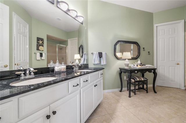 bathroom with tile patterned flooring, vanity, and an enclosed shower