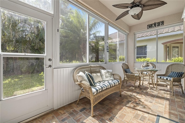 sunroom featuring ceiling fan