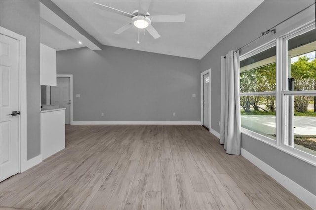 unfurnished living room with ceiling fan, light hardwood / wood-style floors, and lofted ceiling with beams