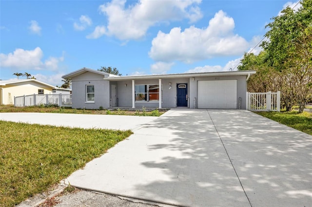 single story home with a front yard and a garage