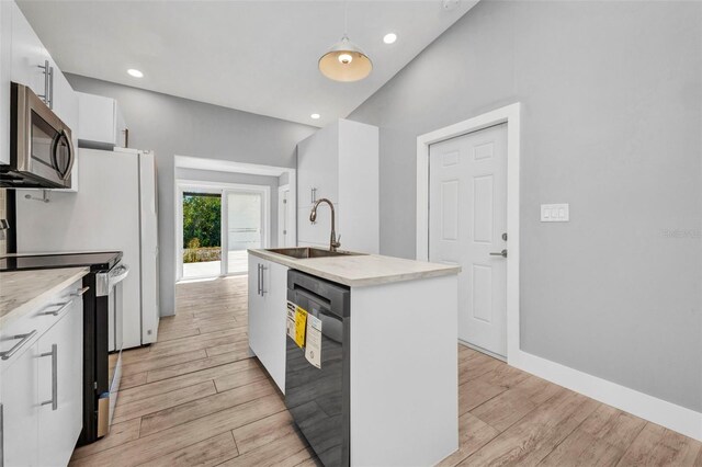 3112 Magnolia Way, Punta Gorda, FL 33950 - kitchen featuring a sink, white cabinets, light wood finished floors, and stainless steel appliances