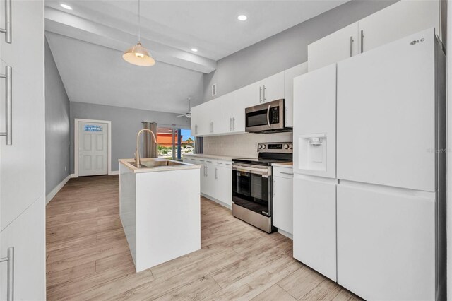3112 Magnolia Way, Punta Gorda, FL 33950 - kitchen with tasteful backsplash, lofted ceiling with beams, light wood-style flooring, appliances with stainless steel finishes, and a sink
