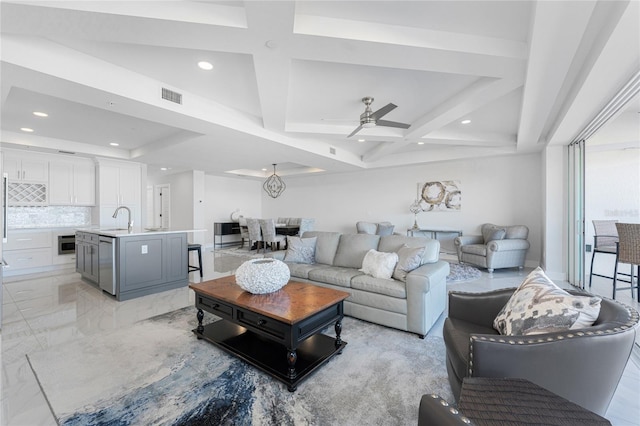 living room featuring coffered ceiling, sink, beamed ceiling, and ceiling fan