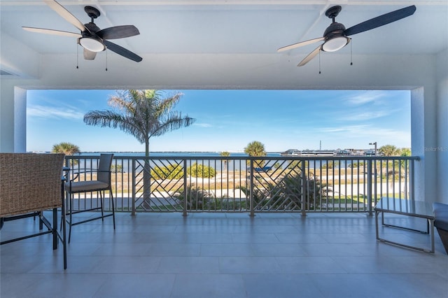 view of patio / terrace with a balcony and a water view