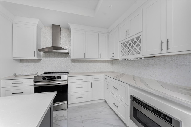 kitchen featuring white cabinetry, built in microwave, stainless steel electric stove, and wall chimney range hood