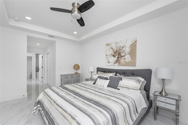 bedroom featuring a raised ceiling and ceiling fan