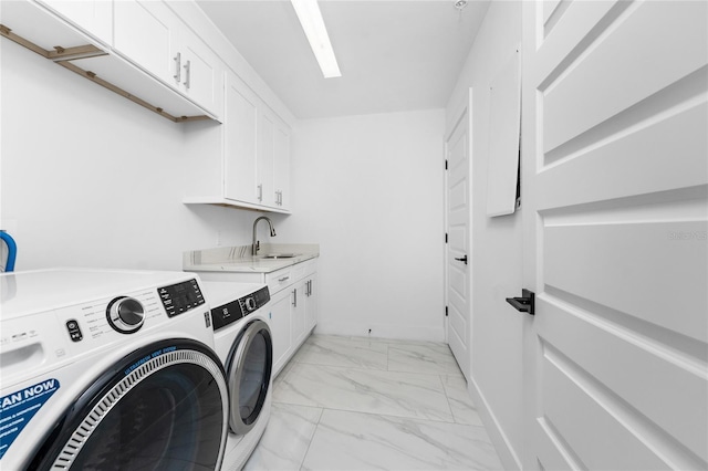 laundry area featuring cabinets, sink, and washing machine and clothes dryer