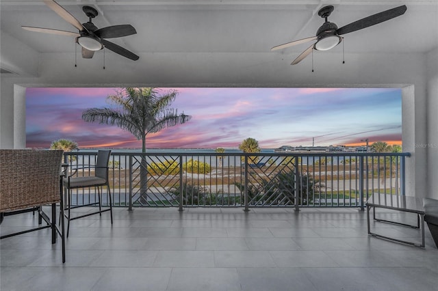 patio terrace at dusk featuring a balcony