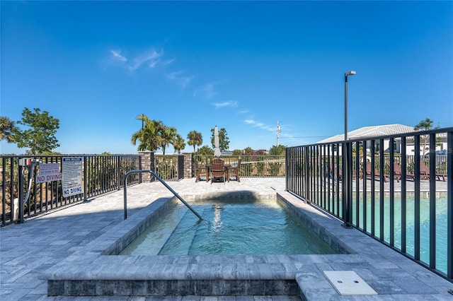 view of pool with a jacuzzi