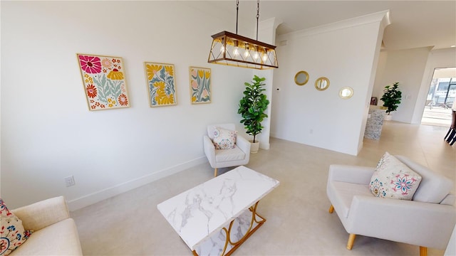 living area with a notable chandelier and ornamental molding