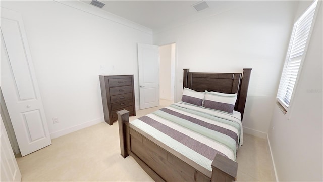 carpeted bedroom with multiple windows and crown molding