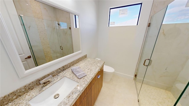 bathroom featuring vanity, an enclosed shower, and toilet