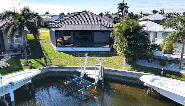 view of dock featuring a lawn and a water view