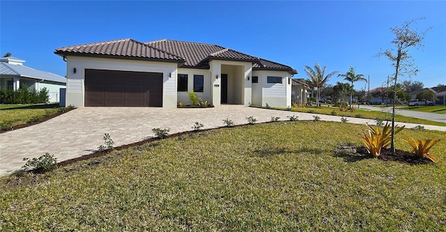 mediterranean / spanish house with a garage and a front yard