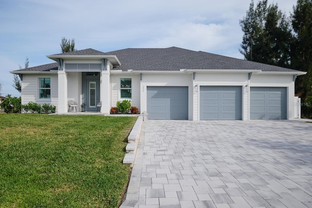 view of front facade with a garage and a front yard