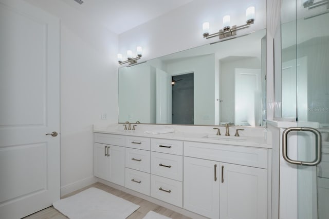 bathroom with an enclosed shower, vanity, hardwood / wood-style flooring, and ceiling fan