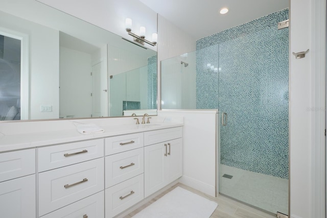 bathroom featuring vanity and an enclosed shower